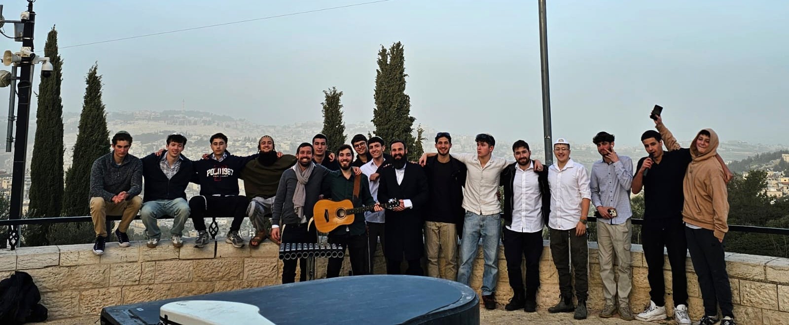 Bochurim with guitar overlooking Yerushalayim